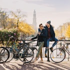 Gay couple enjoying by an Amsterdam canal in late autumn