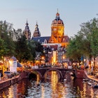 2154447062
Red Light District with crowds of people and Basilica of Saint Nicholas illuminated at dusk, Amsterdam, Netherlands - stock photo